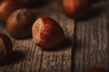 close up view of shelled hazelnuts on wooden tabletop