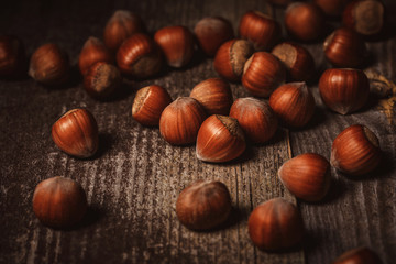 close up view of shelled hazelnuts on wooden backdrop