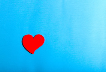 Red single heart light blue background. Medicine and Valentine's Day concept. Horizontal, space for text, top view.