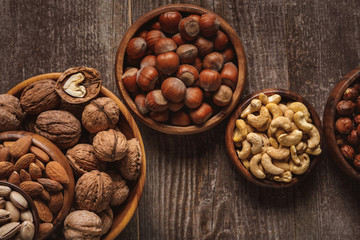 top view of nuts in bowls arranged on wooden tabletop