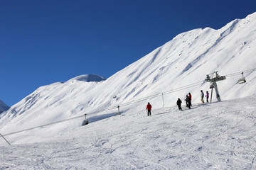 Fototapeta na wymiar Skiers riding the slope