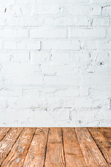 white brick wall and wooden table