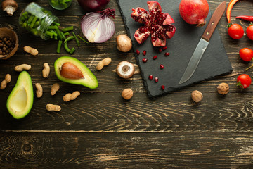Vegan food, detox, avocado, fruit, green beans, broccoli, nuts and mushrooms. Diet and healthy food, vitamins and sports. Flat-lay, Clean and healthy food on a wooden background.