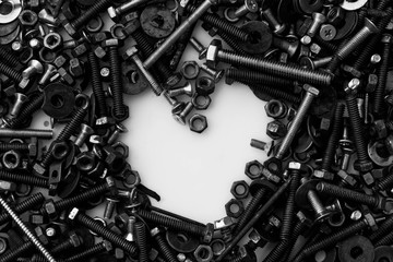 Assorted nuts and bolts heart on white background