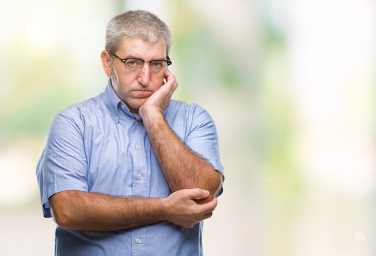 Handsome senior man wearing glasses over isolated background thinking looking tired and bored with depression problems with crossed arms.