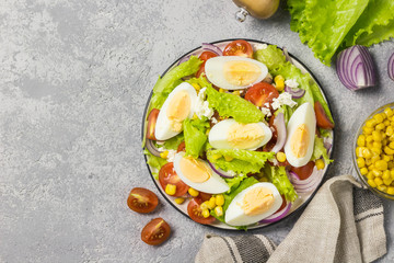 Egg tomato corn salad with mustard olive oil dressing. Top view, space for text.