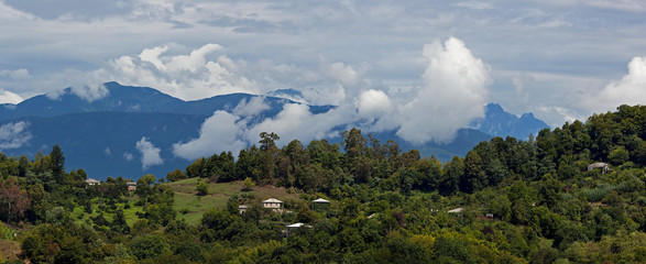 View of the mountains with sky and clouds above them.