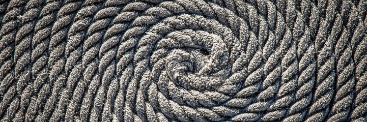 The rope for the boat laid in the form of a spiral. Background.