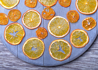 Dried orange slices on gray wooden background