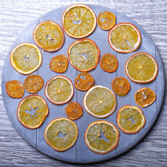 Dried orange slices on gray wooden background