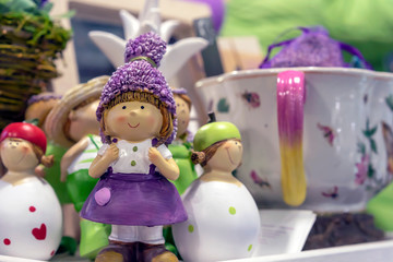 Figurine of a little girl in a lilac dress in a souvenir shop.