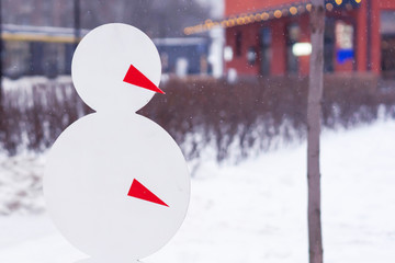 Abstract figure of a snowman on the background of falling snow.