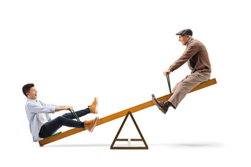 Teenage boy with his grandfather on a seesaw