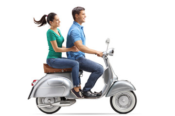 Young couple riding on a vintage motorbike
