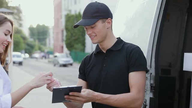 Delivery Courier Service. Man Delivering Package To Woman