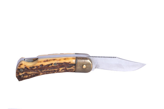 Isolated image of an old sharp folding metal knife with antler handle on white background