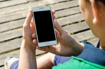 Close Up Hipster Business Man Using Smartphone Mobile Phone Outdoor Black Oled Display Background paving Stone Stylish greenery Dressed