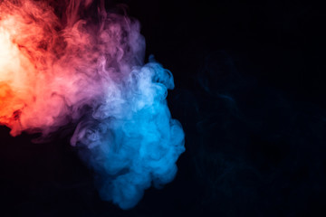 A cloud of smoke evaporating in soft waves with a rainbow effect: red, orange, yellow, green, cyan, magenta, colors on a dark background.