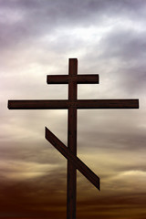 Large Christian cross against a background lowering sky