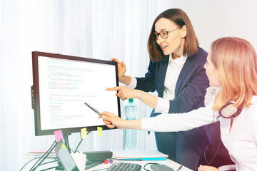 Women discussing business project in the office