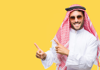Young handsome man wearing keffiyeh over isolated background smiling and looking at the camera...