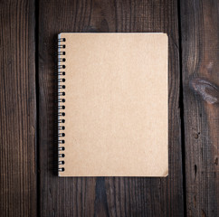 notebook on a black iron spring with brown empty sheets