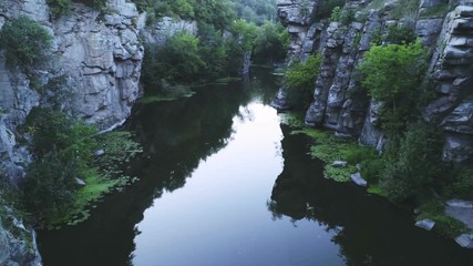 Thrilling mountain creek flowing between high rocks in the Carpathians in summer