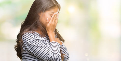 Young beautiful arab woman wearing sunglasses over isolated background with sad expression covering face with hands while crying. Depression concept.