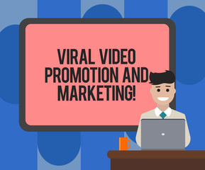 Handwriting text writing Viral Video Promotion And Marketing. Concept meaning Modern advertising social media strategy Blank Bordered Board behind Man Sitting Smiling with Laptop Mug on Desk