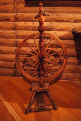 Old traditional Russian wooden spinning wheel in village house