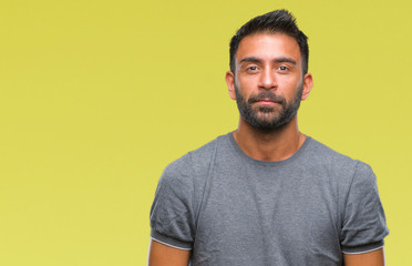 Adult hispanic man over isolated background with serious expression on face. Simple and natural...