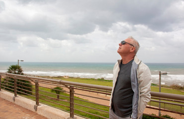 Successful matur man on the background of the sea