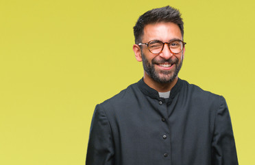Adult hispanic catholic priest man over isolated background winking looking at the camera with sexy...