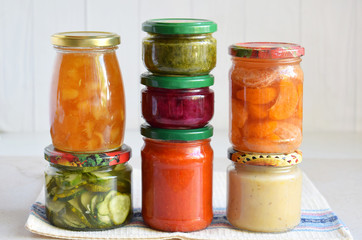 Variety of preserved food in glass jars - pickles, jam, marmalade, sauces, ketchup. Preserving vegetables and fruits. Fermented food. Autumn canning. Conservation of harvest