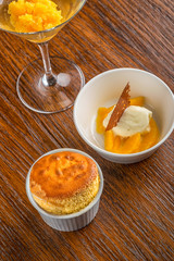 vanilla souffle with mango sorbet and vanilla ice cream with served on wooden table, product photography for restaurant