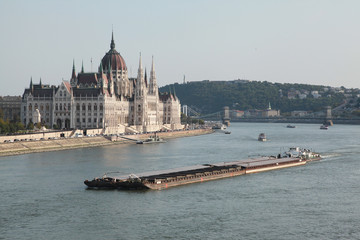 The view of the Budapest Parliament and the barge on Danube River