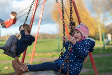 Obraz premium Child on the swing in the playground