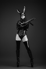 Young army woman in latex costume with a rabbit mask