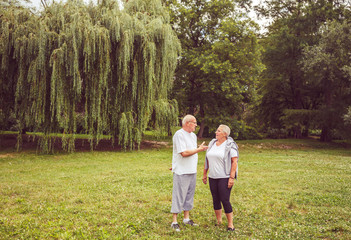 Naklejka na ściany i meble Senior exercise - Senior couple enjoying a moment and talking together.