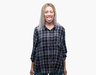Fototapeta premium Young blonde woman over isolated background sticking tongue out happy with funny expression. Emotion concept.
