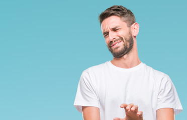Young handsome man over isolated background disgusted expression, displeased and fearful doing...