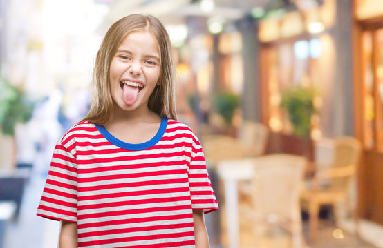 Young beautiful girl over isolated background sticking tongue out happy with funny expression. Emotion concept.
