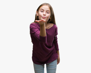 Fototapeta premium Young beautiful girl over isolated background looking at the camera blowing a kiss with hand on air being lovely and sexy. Love expression.