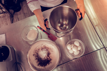Top view of a cook taking the saucepan