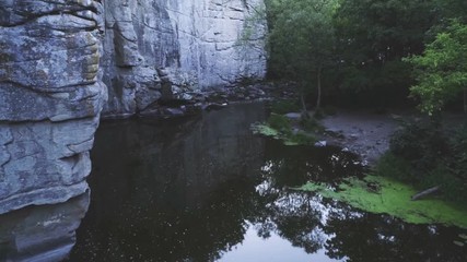 Mountain creek running at a vertical stony barragel in the Carpathian in summer