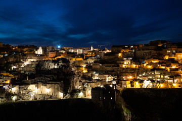 Panorama of Matera and Gravina by night seen from the archaeological park of the Murge Materane, Basilicata, Italy