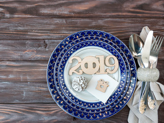 Holiday server table. Plates in classic style. New Year and Christmas flat lay. Cones and Christmas...