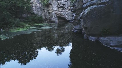 Mountain brook running between high rocks with grots in Carpathians in summer