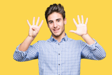 Young handsome business man over isolated background showing and pointing up with fingers number nine while smiling confident and happy.