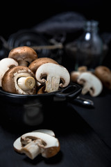 Champignon mushroom on the dark table moody